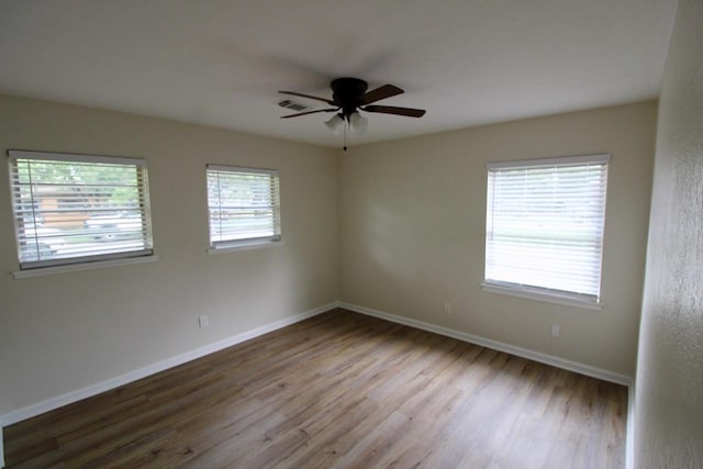 1215 Maplewood Ln, Pasadena, TX 77502 - empty room with wood finished floors, baseboards, and a ceiling fan