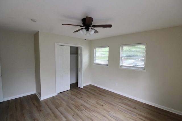 1215 Maplewood Ln, Pasadena, TX 77502 - unfurnished bedroom with wood finished floors, baseboards, a closet, and a ceiling fan