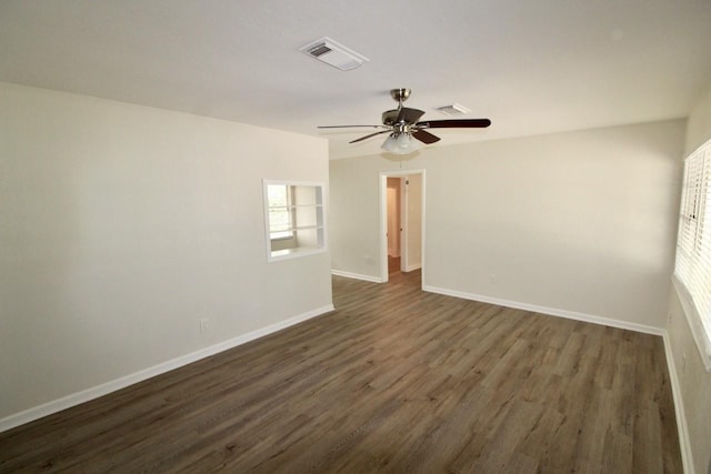 1215 Maplewood Ln, Pasadena, TX 77502 - spare room with dark wood-type flooring, ceiling fan, and baseboards