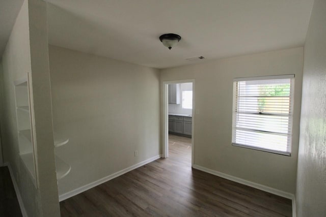1215 Maplewood Ln, Pasadena, TX 77502 - spare room with dark wood-style floors and baseboards
