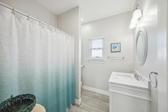 22409 Vista Del Mar, Galveston, TX 77554 - full bathroom featuring wood finished floors, toilet, baseboards, and vanity