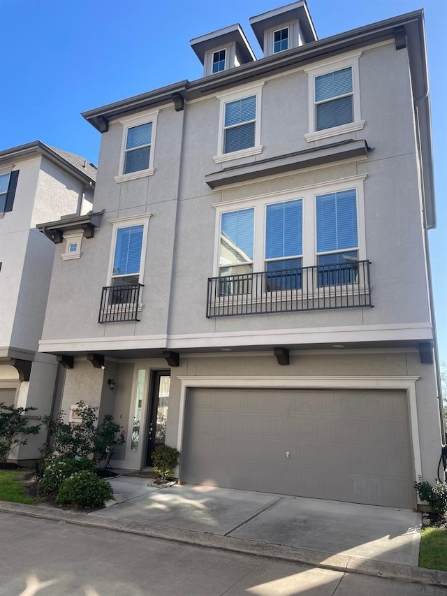 9611 Knights Station Dr, Houston, TX 77045 - view of front facade with stucco siding, an attached garage, and driveway