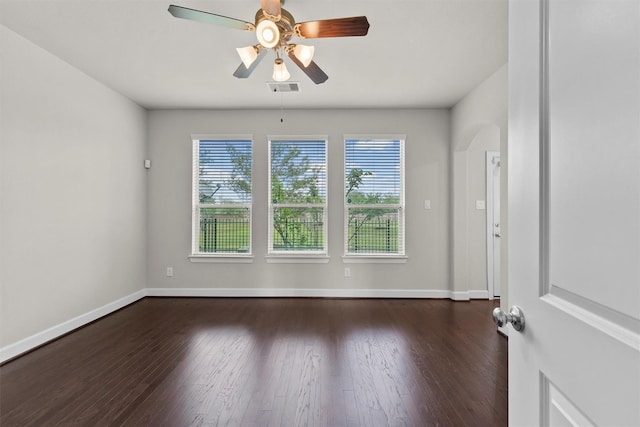 9611 Knights Station Dr, Houston, TX 77045 - empty room featuring dark wood-type flooring, a ceiling fan, and baseboards