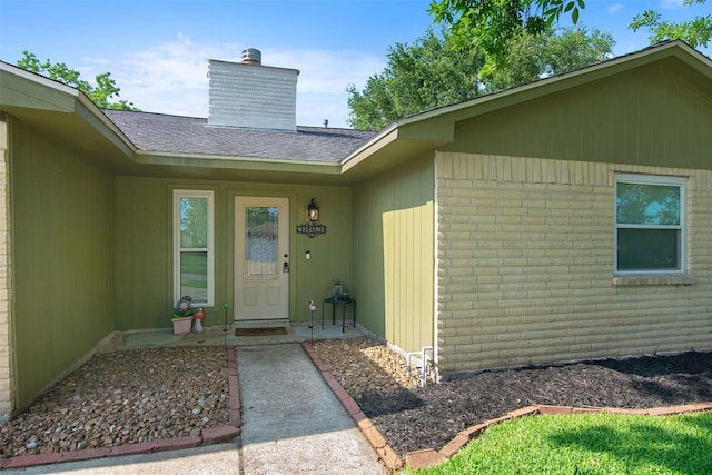 24 Wagon Lane Loop, Angleton, TX 77515 - entrance to property featuring a chimney and roof with shingles