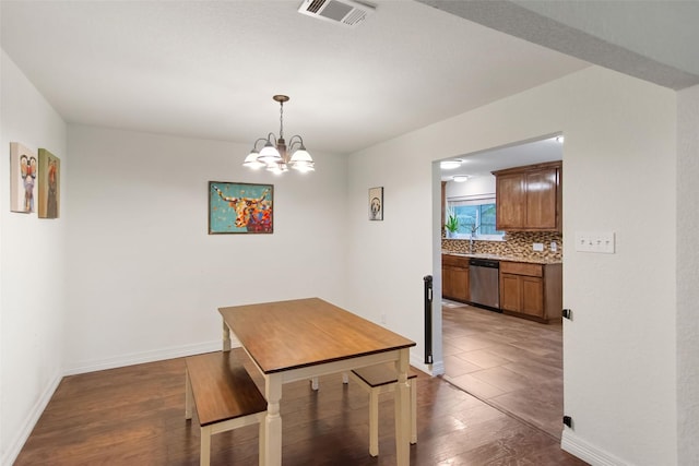 24 Wagon Lane Loop, Angleton, TX 77515 - dining room featuring dark wood-style floors, baseboards, and a chandelier