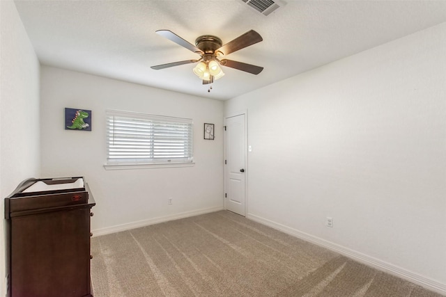 24 Wagon Lane Loop, Angleton, TX 77515 - spare room featuring carpet, a ceiling fan, and baseboards