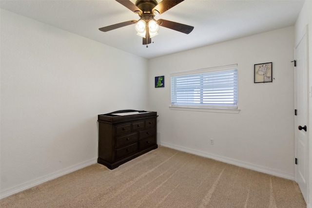24 Wagon Lane Loop, Angleton, TX 77515 - unfurnished bedroom with light colored carpet, baseboards, and ceiling fan