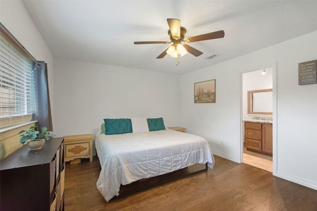 24 Wagon Lane Loop, Angleton, TX 77515 - bedroom with dark wood-style flooring, ceiling fan, baseboards, and ensuite bath