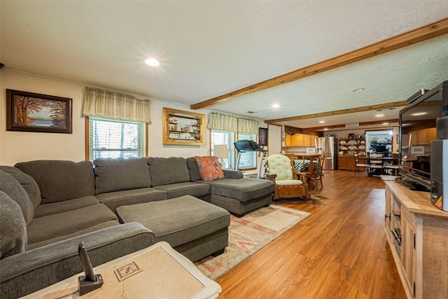 12857 Fm 1485th Rd, Conroe, TX 77306 - living area with light wood finished floors, beamed ceiling, healthy amount of natural light, and recessed lighting