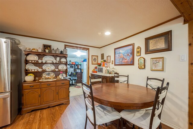12857 Fm 1485th Rd, Conroe, TX 77306 - dining area featuring crown molding, light wood-style flooring, and recessed lighting