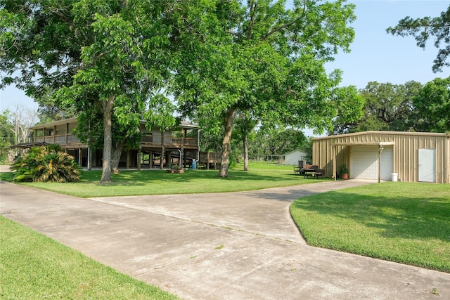 915 Live Oak Dr, Jones Creek, TX 77541 - view of property's community featuring concrete driveway, a garage, and a lawn