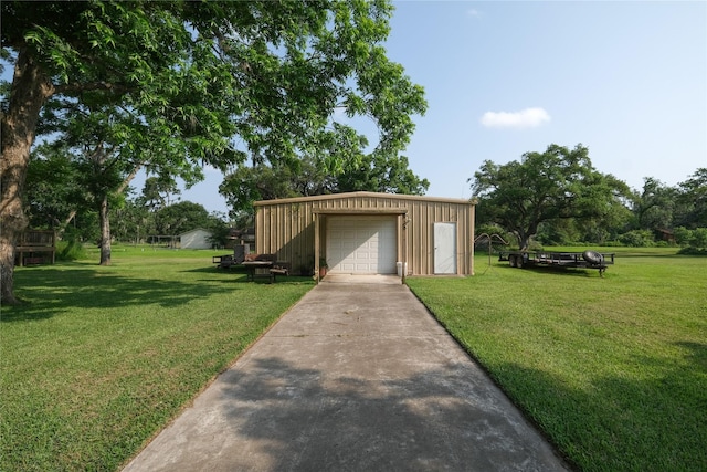 915 Live Oak Dr, Jones Creek, TX 77541 - view of grassy yard with driveway, an outbuilding, and a detached garage