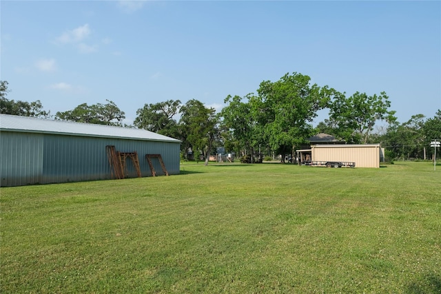 915 Live Oak Dr, Jones Creek, TX 77541 - view of grassy yard with a pole building and an outdoor structure