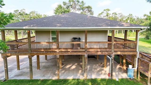 915 Live Oak Dr, Jones Creek, TX 77541 - rear view of house featuring a shingled roof, a deck, and a patio area