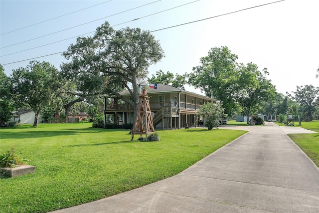 915 Live Oak Dr, Jones Creek, TX 77541 - view of green lawn featuring driveway