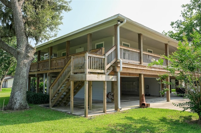915 Live Oak Dr, Jones Creek, TX 77541 - back of house featuring a lawn and an attached garage