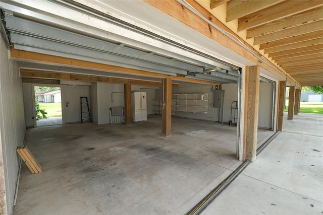 915 Live Oak Dr, Jones Creek, TX 77541 - garage featuring electric panel and freestanding refrigerator