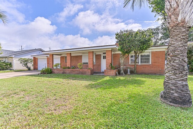 2920 Heron Dr, Galveston, TX 77551 - ranch-style home featuring concrete driveway, brick siding, an attached garage, and a front yard