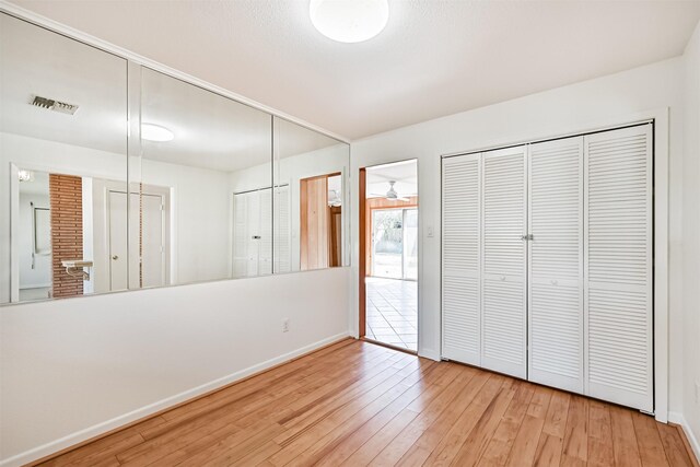 2920 Heron Dr, Galveston, TX 77551 - unfurnished bedroom with hardwood / wood-style flooring, baseboards, and ensuite bathroom