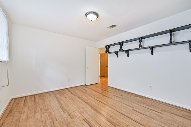 2920 Heron Dr, Galveston, TX 77551 - empty room with light wood-style flooring and baseboards