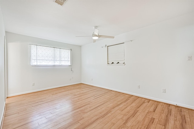 2920 Heron Dr, Galveston, TX 77551 - spare room featuring light wood-style floors, a ceiling fan, and baseboards