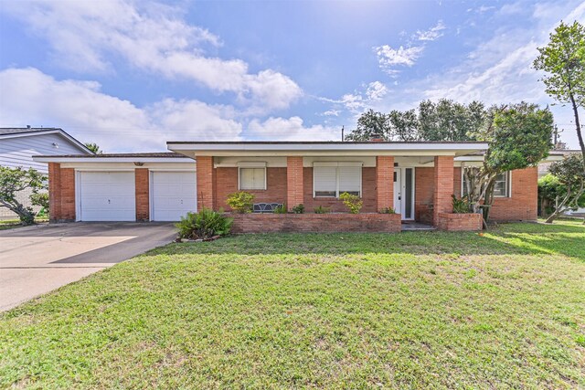 2920 Heron Dr, Galveston, TX 77551 - single story home featuring a garage, a front lawn, driveway, and brick siding