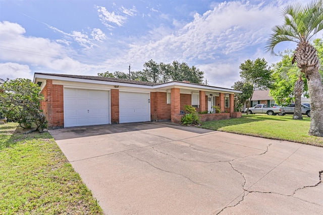 2920 Heron Dr, Galveston, TX 77551 - ranch-style home with brick siding, an attached garage, a front yard, and driveway