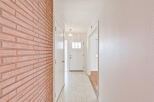 2920 Heron Dr, Galveston, TX 77551 - corridor featuring light flooring, a chandelier, and baseboards