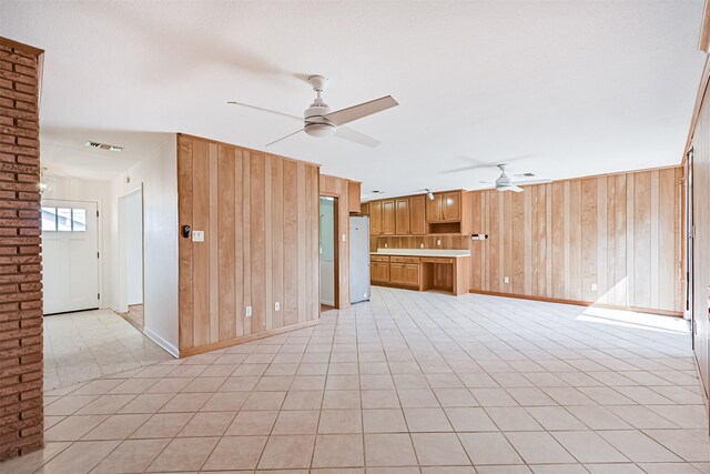 2920 Heron Dr, Galveston, TX 77551 - unfurnished living room featuring a ceiling fan, wooden walls, and baseboards