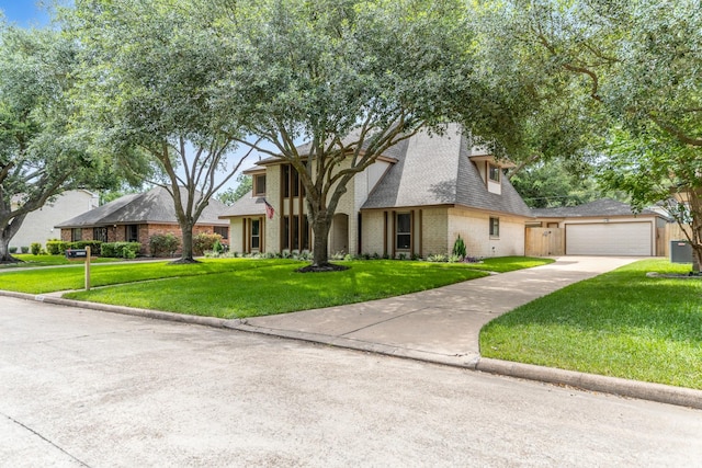 15735 Mesa Gardens Dr, Houston, TX 77095 - view of front facade with brick siding, a front lawn, an outdoor structure, roof with shingles, and concrete driveway