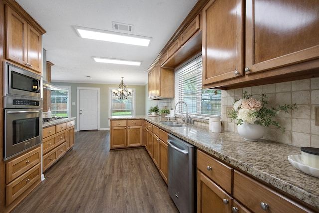 15735 Mesa Gardens Dr, Houston, TX 77095 - kitchen with appliances with stainless steel finishes, a sink, dark wood finished floors, and decorative backsplash