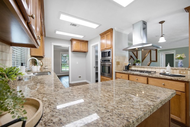 15735 Mesa Gardens Dr, Houston, TX 77095 - kitchen with appliances with stainless steel finishes, island range hood, a peninsula, backsplash, and light stone countertops