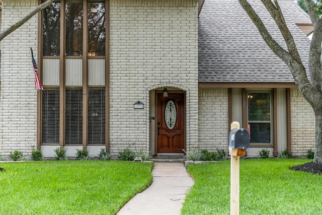15735 Mesa Gardens Dr, Houston, TX 77095 - view of front of house featuring brick siding, a front lawn, and roof with shingles
