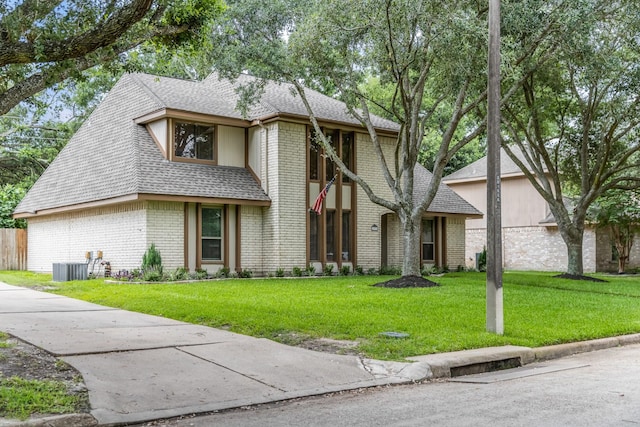 15735 Mesa Gardens Dr, Houston, TX 77095 - view of front of house featuring brick siding, a shingled roof, and a front lawn