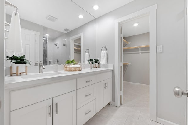 15735 Mesa Gardens Dr, Houston, TX 77095 - full bathroom with double vanity, a shower stall, a spacious closet, recessed lighting, and baseboards
