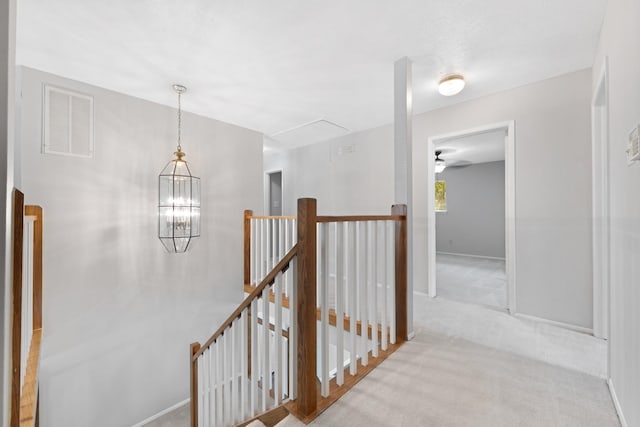 15735 Mesa Gardens Dr, Houston, TX 77095 - corridor featuring an upstairs landing, attic access, carpet flooring, baseboards, and a chandelier