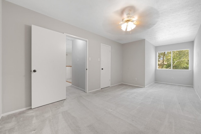15735 Mesa Gardens Dr, Houston, TX 77095 - unfurnished bedroom featuring light colored carpet, baseboards, and a ceiling fan