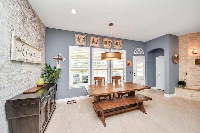 5131 Kingship Ct, Katy, TX 77493 - dining space featuring arched walkways, baseboards, and light tile patterned floors