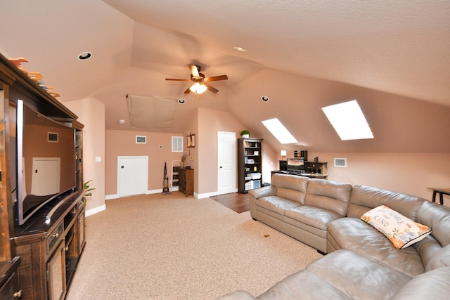 5131 Kingship Ct, Katy, TX 77493 - carpeted living room featuring a skylight, vaulted ceiling, baseboards, a ceiling fan, and recessed lighting