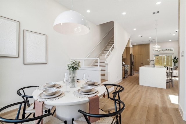 612 Hughes St Unit B, Houston, TX 77023 - dining room with light wood-style flooring, stairs, recessed lighting, and baseboards
