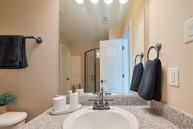 1623 Whitfield St, Sugar Land, TX 77479 - bathroom featuring toilet, a stall shower, a textured wall, and vanity