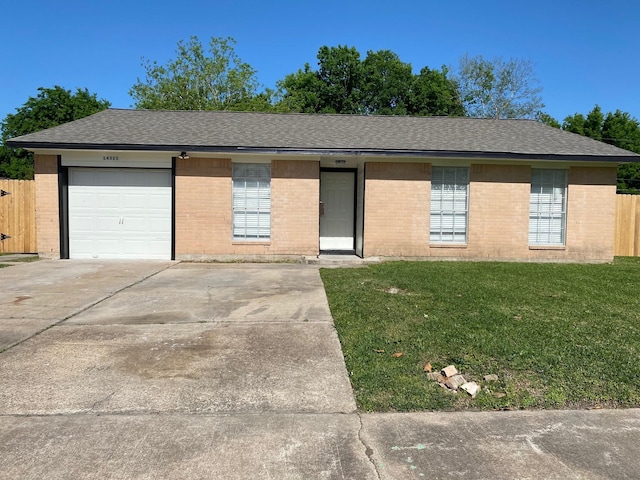 14311 Waterloo Dr, Houston, TX 77045 - single story home with brick siding, roof with shingles, concrete driveway, and an attached garage