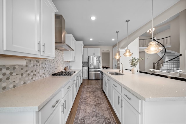 8211 Barristan Bluffs Ct, Magnolia, TX 77354 - kitchen with wall chimney exhaust hood, a sink, stainless steel appliances, dark wood finished floors, and recessed lighting