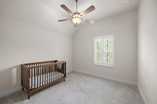 8211 Barristan Bluffs Ct, Magnolia, TX 77354 - carpeted bedroom with vaulted ceiling, baseboards, ceiling fan, and a crib