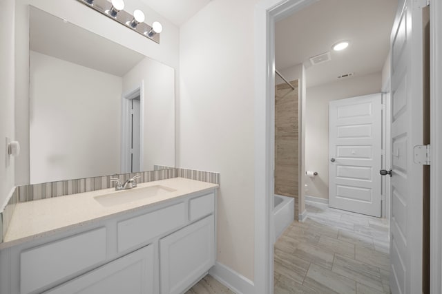 8211 Barristan Bluffs Ct, Magnolia, TX 77354 - full bathroom featuring vanity, baseboards, and bathtub / shower combination