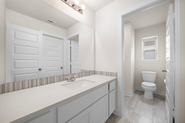 8211 Barristan Bluffs Ct, Magnolia, TX 77354 - bathroom featuring vanity, toilet, and baseboards