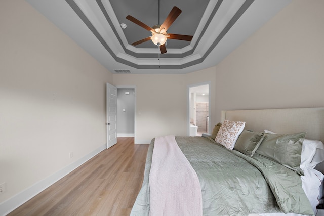 8211 Barristan Bluffs Ct, Magnolia, TX 77354 - bedroom with a raised ceiling, light wood-type flooring, baseboards, crown molding, and a ceiling fan