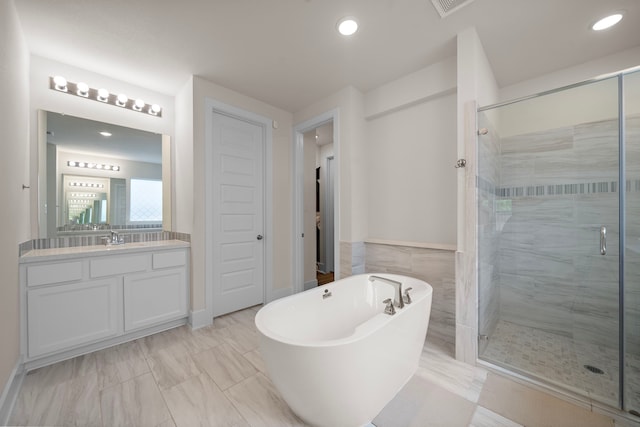8211 Barristan Bluffs Ct, Magnolia, TX 77354 - full bathroom featuring a shower stall, a freestanding tub, vanity, recessed lighting, and marble finish flooring