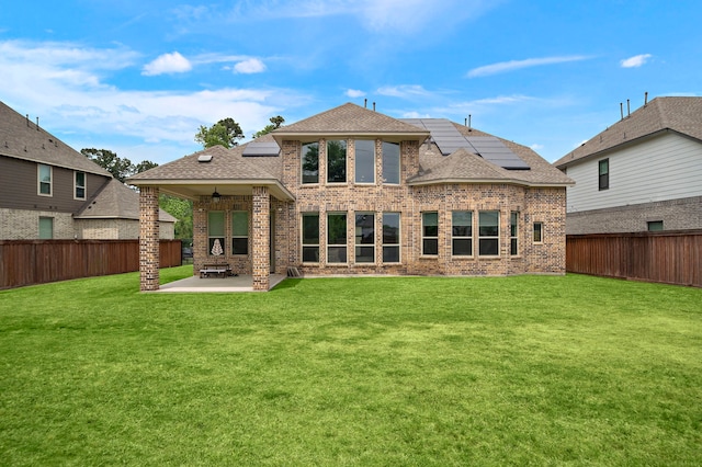 8211 Barristan Bluffs Ct, Magnolia, TX 77354 - back of house with a patio area, roof mounted solar panels, brick siding, and roof with shingles