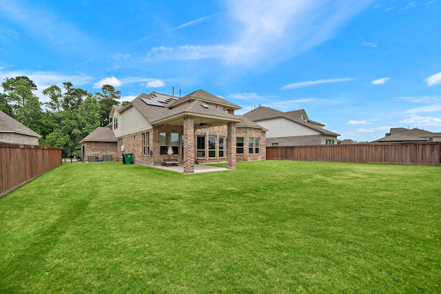8211 Barristan Bluffs Ct, Magnolia, TX 77354 - rear view of house featuring a patio, brick siding, roof mounted solar panels, a shingled roof, and ceiling fan
